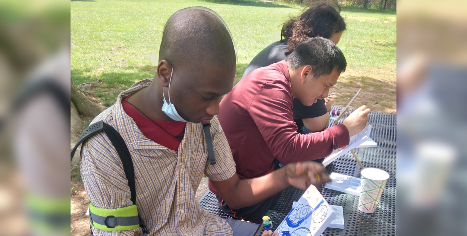 Men doing arts and crafts outdoors