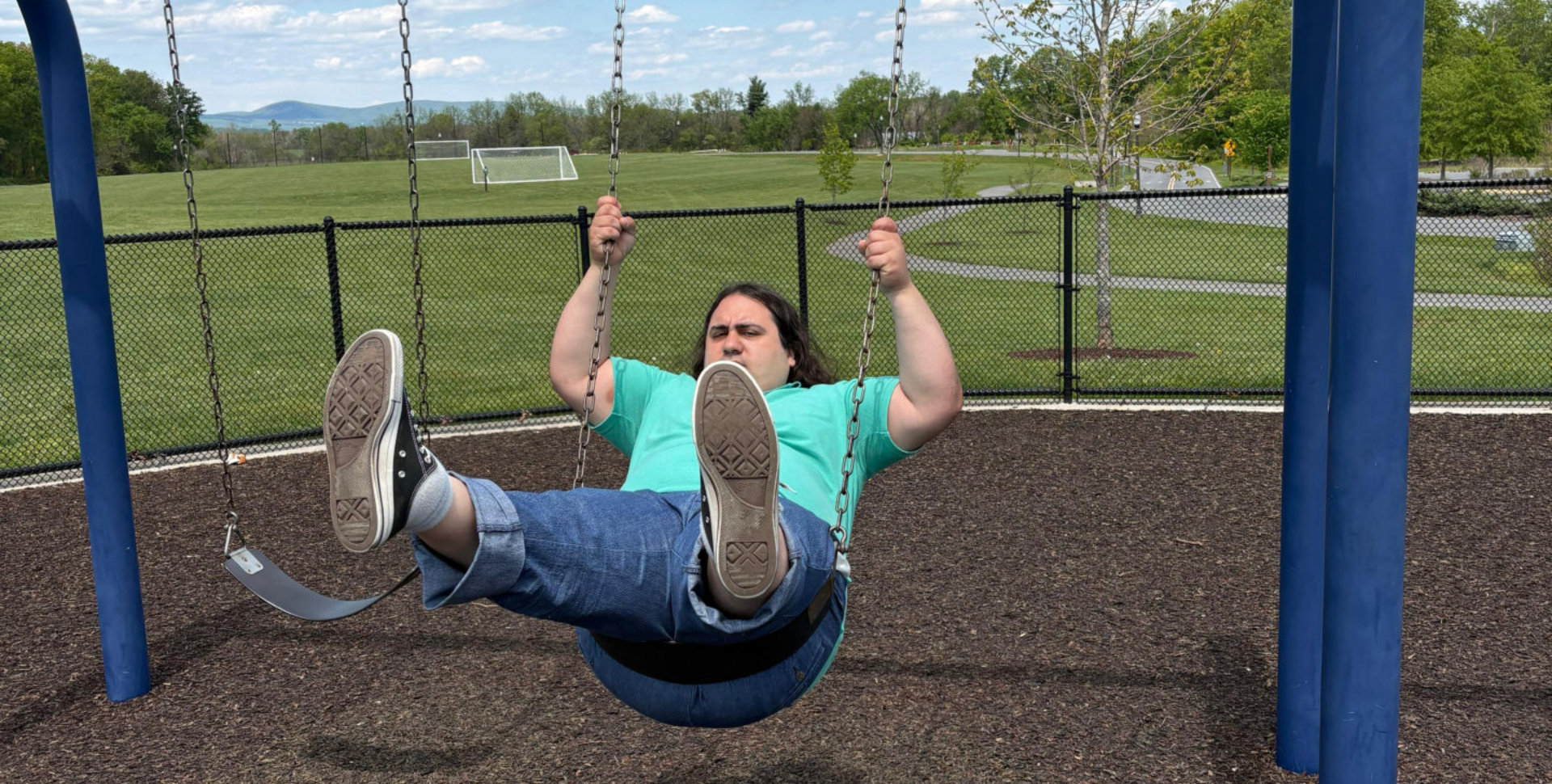 Man playing with swing outdoors